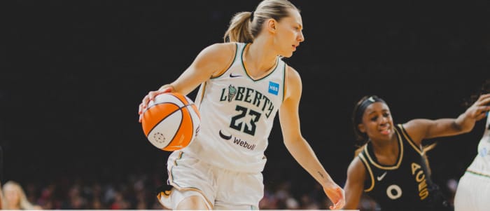 Marine Johannes (23) sustained the Liberty in the early going but they failed to contain Jackie Young (0) and the Aces' other scorers